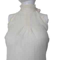 White top with lace details on a white background