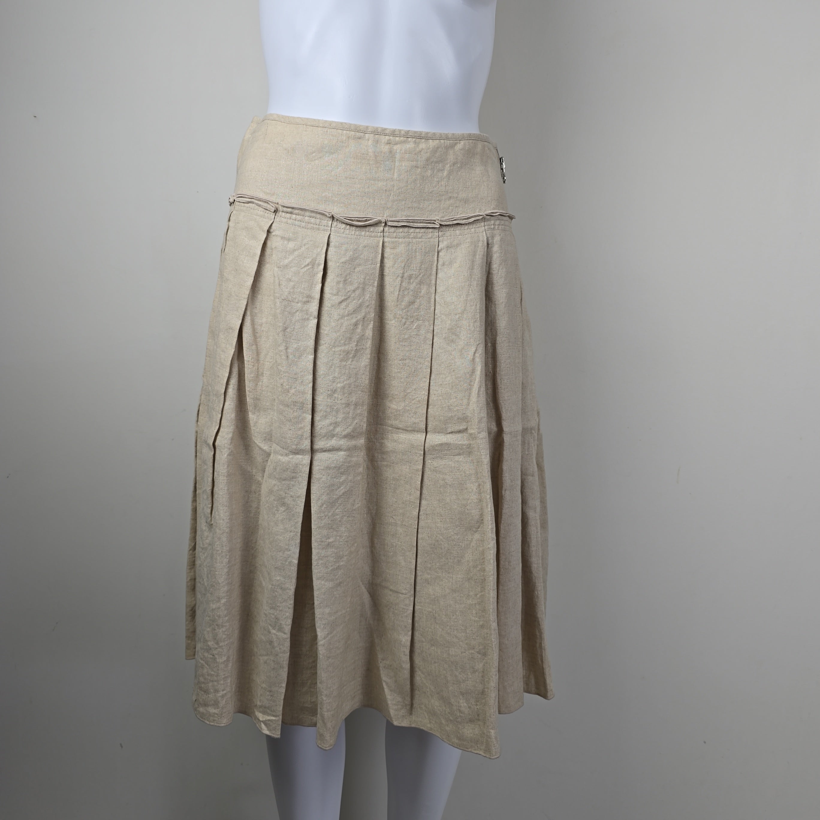 Beige pleated skirt on a gray background