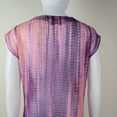 Purple and pink patterned fabric draped over a white surface