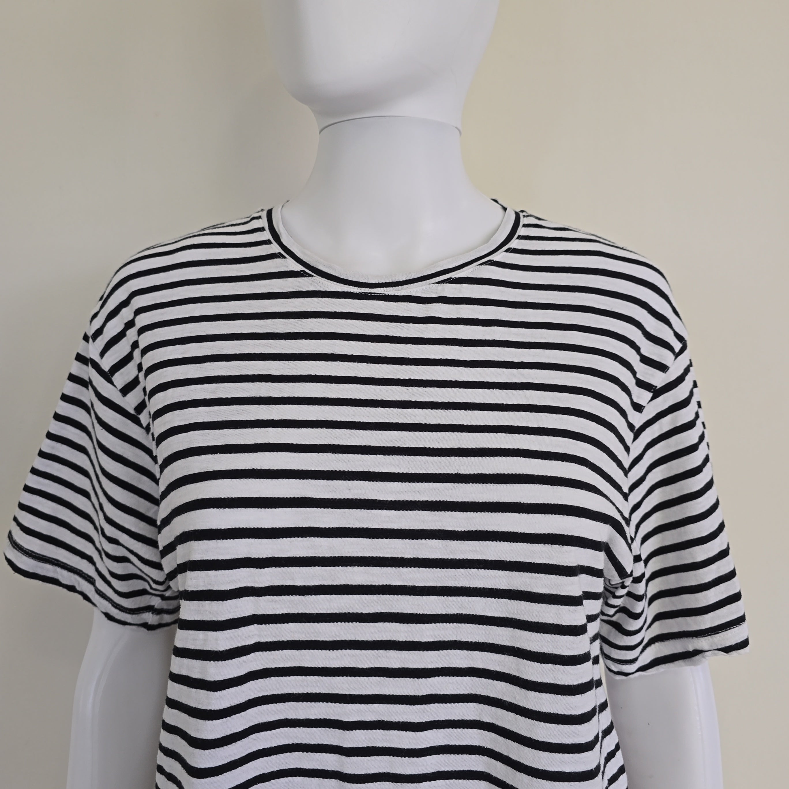 Black and white striped top on a mannequin against a plain background