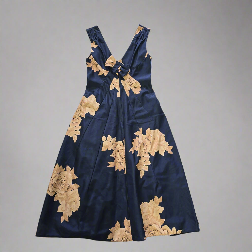 Navy blue dress with gold floral patterns on a plain background