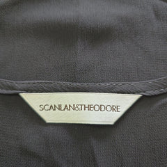 Close-up of a label on a dark fabric with 'SCANLAN & THEODORE' branding.
