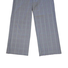 Two gray checkered pant legs on a tiled floor.