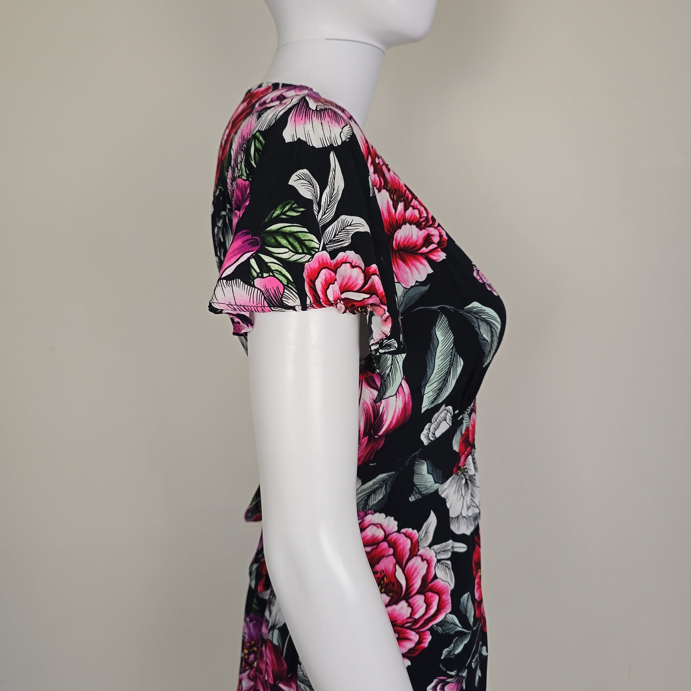 Floral dress on a mannequin with a plain background