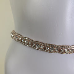 Gold belt on a mannequin against a white background