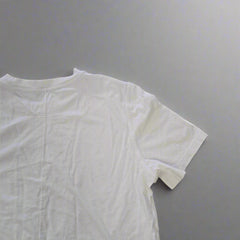 White t-shirt on a tiled floor