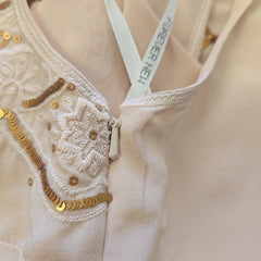 Close-up of a beige garment with lace details and 'Forever New' label.