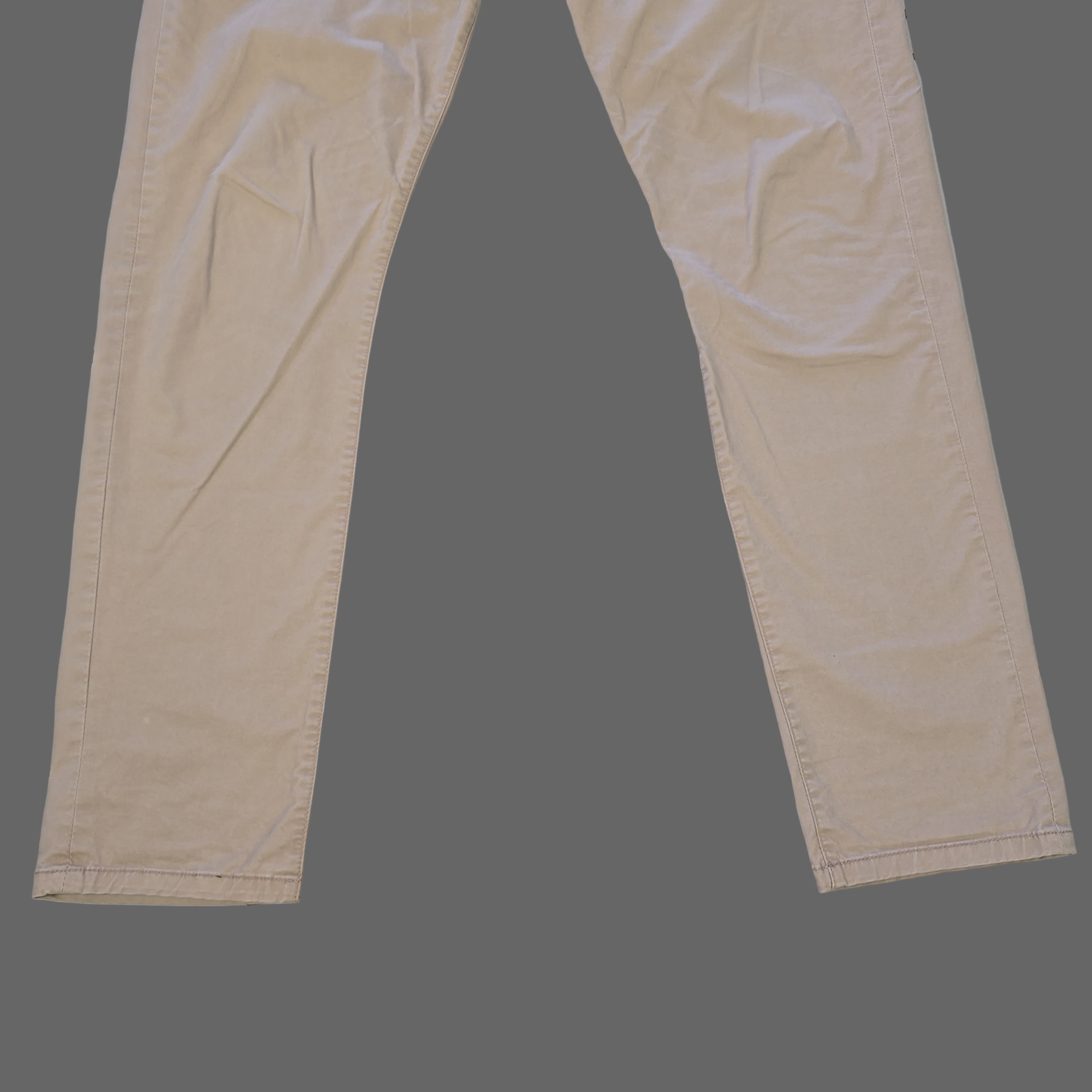 Beige pants laid flat on a tiled floor