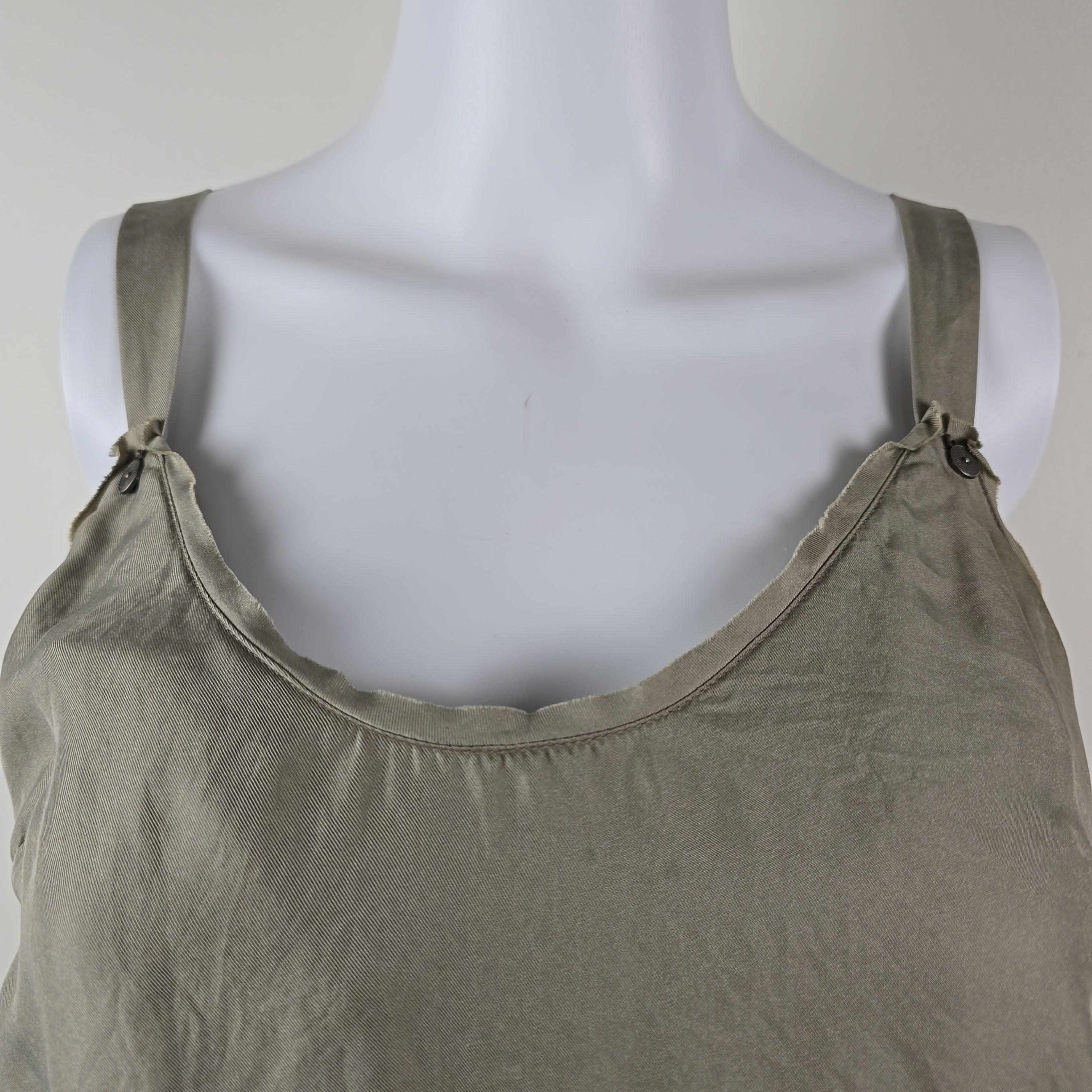 Grey tank top on a mannequin with a plain background