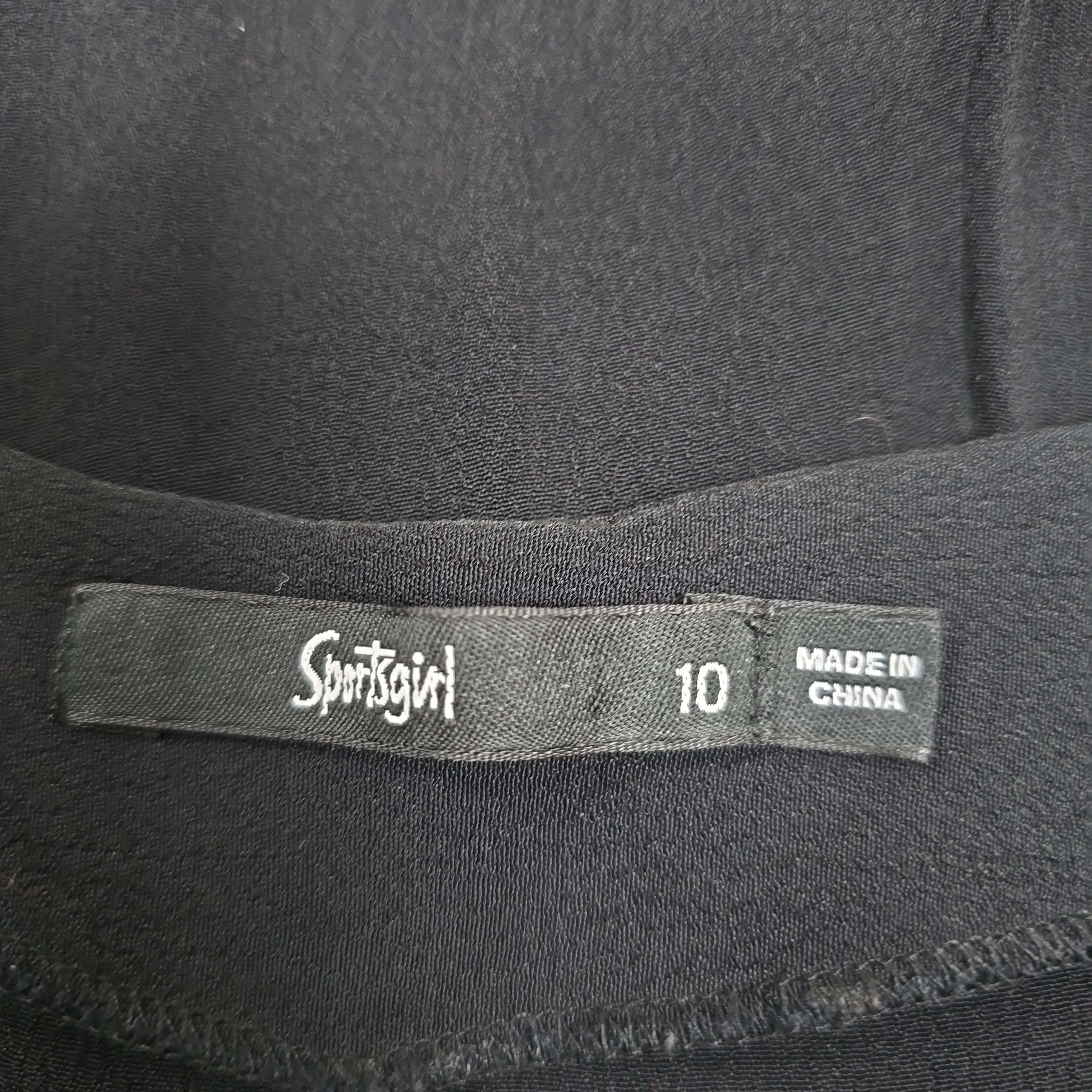 Close-up of a label on a black garment with 'Sportsgirl' brand name.