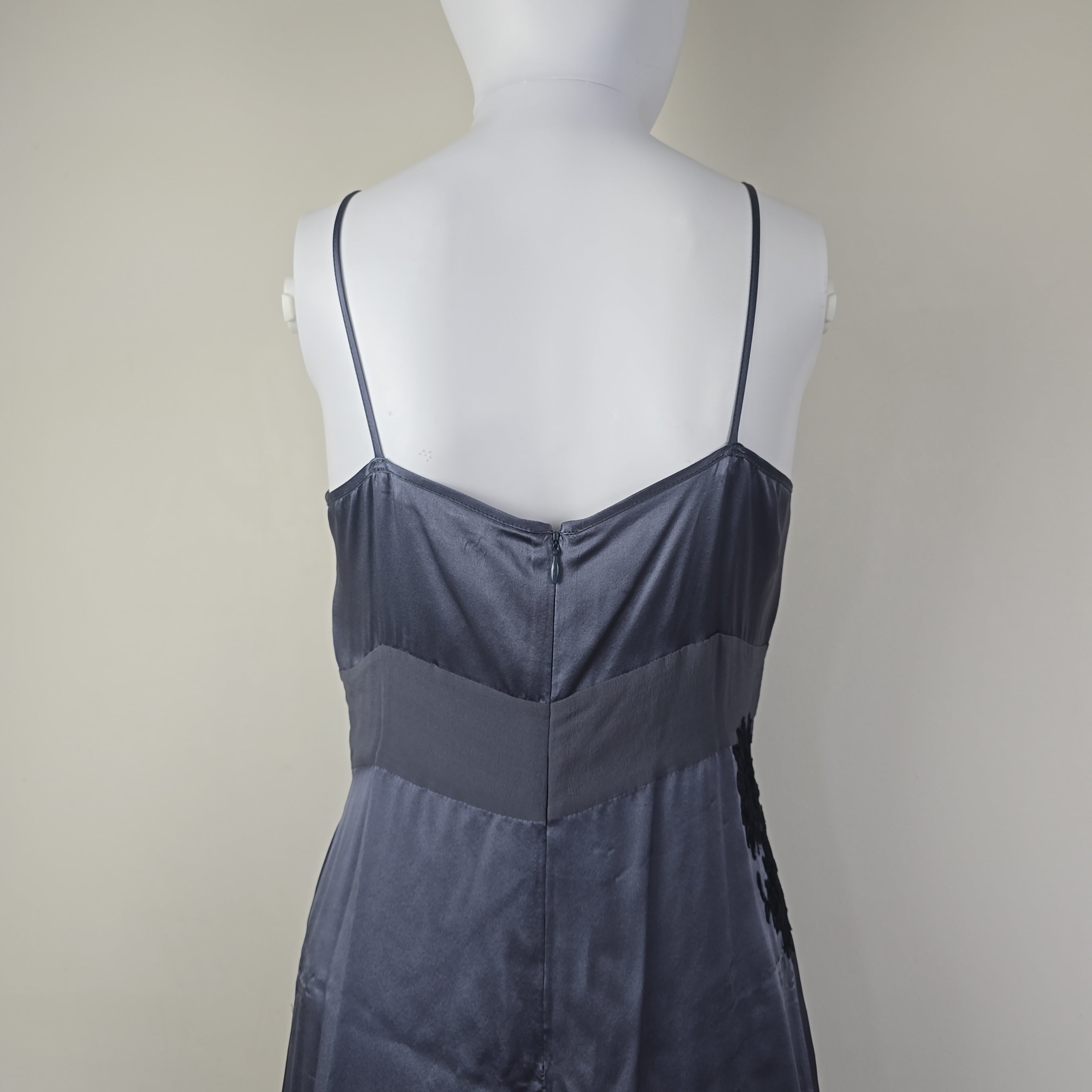 Grey dress with black floral patterns on a light background.