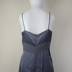 Grey dress with black floral patterns on a light background.