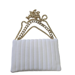 White handbag with a gold chain on a light background
