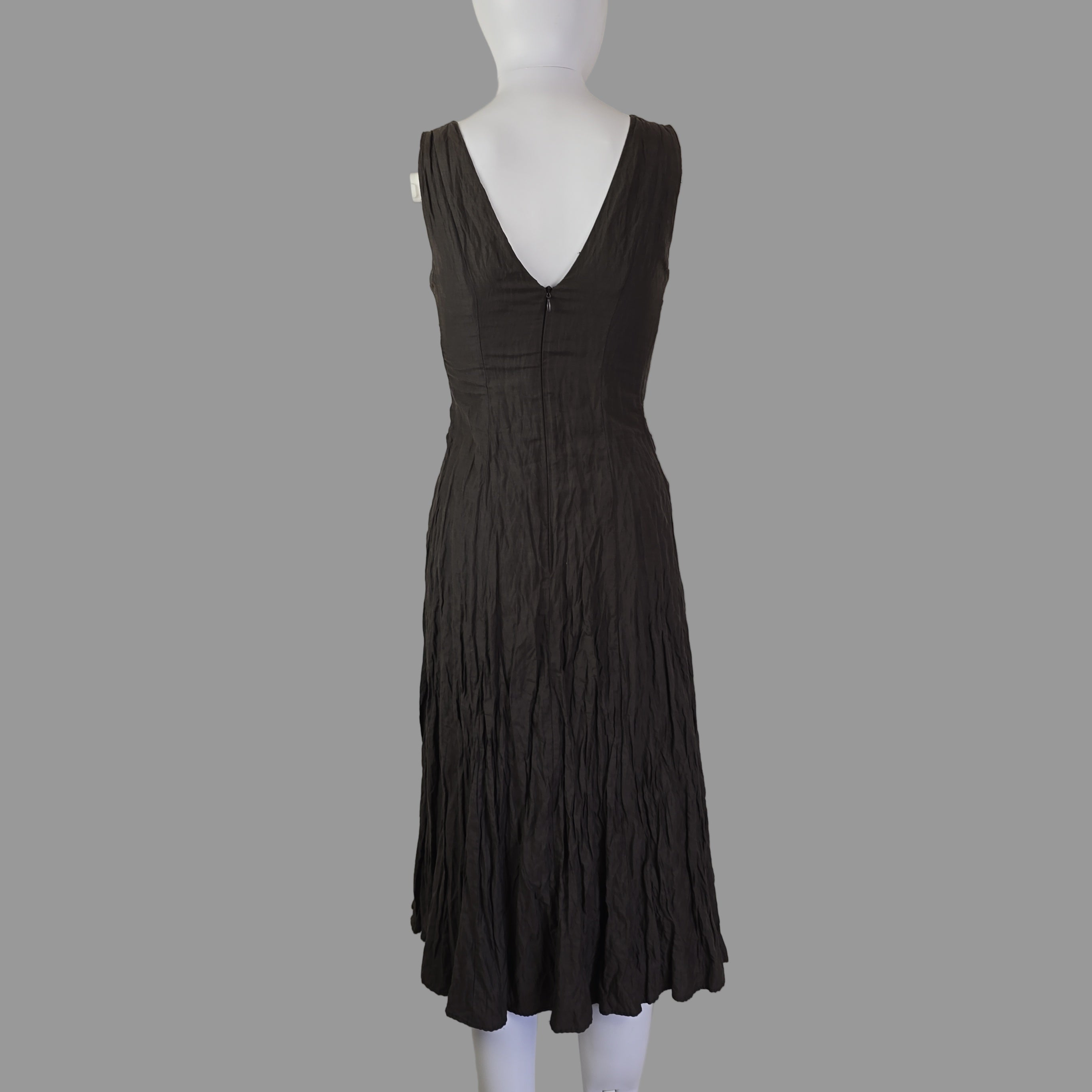 Black strapless dress on a mannequin against a plain background