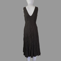Black strapless dress on a mannequin against a plain background