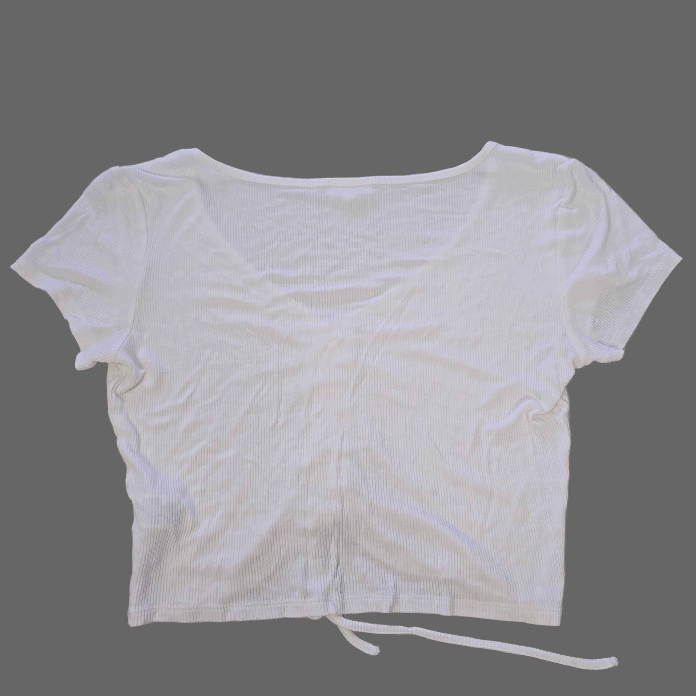 White top on a tiled floor