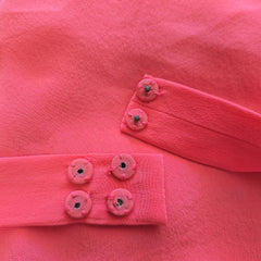Close-up of bright pink buttons.