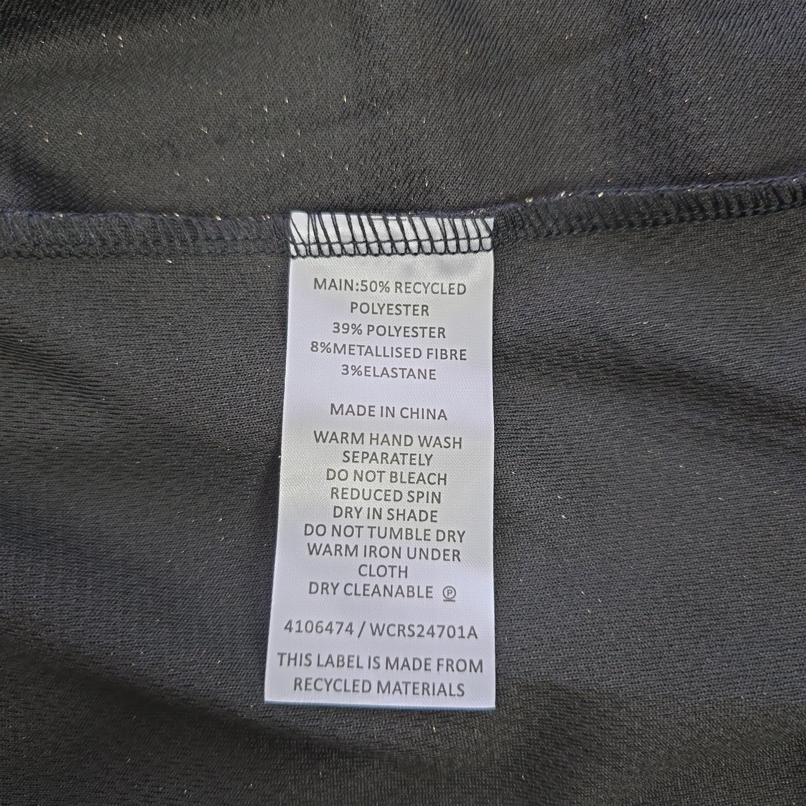 Clothing label on a dark fabric background