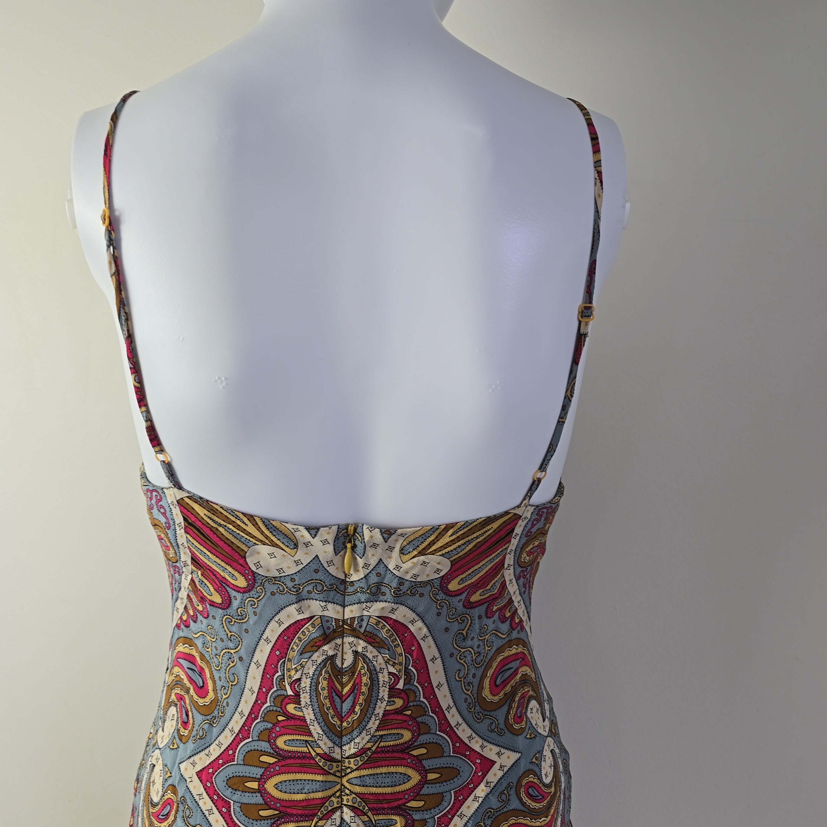 Colorful patterned top on a mannequin against a neutral background