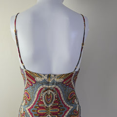 Colorful patterned top on a mannequin against a neutral background