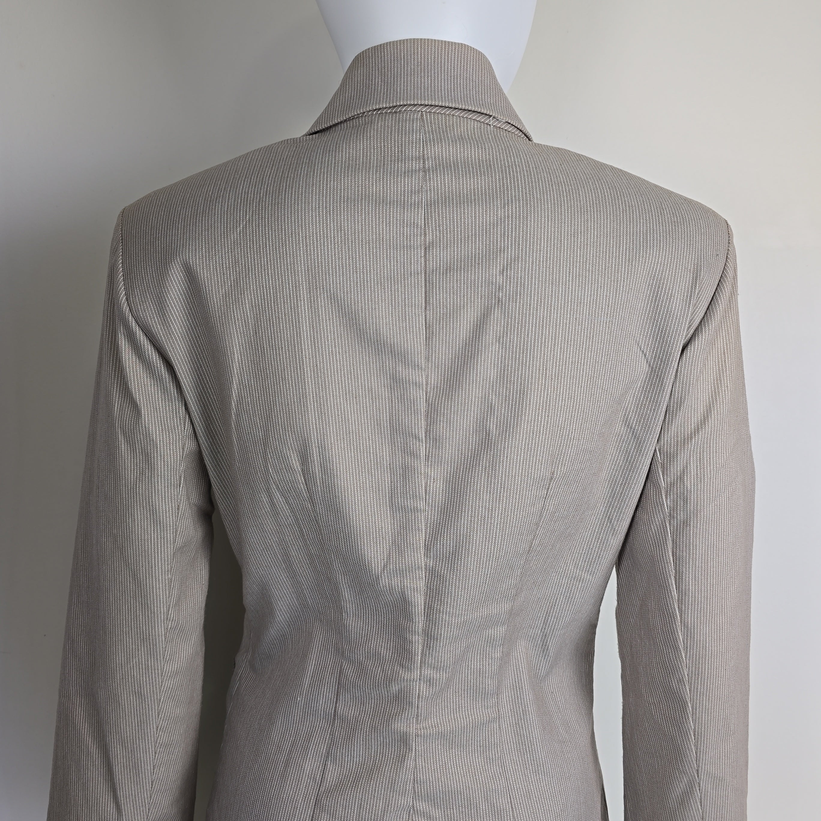 Gray jacket on a mannequin against a white background