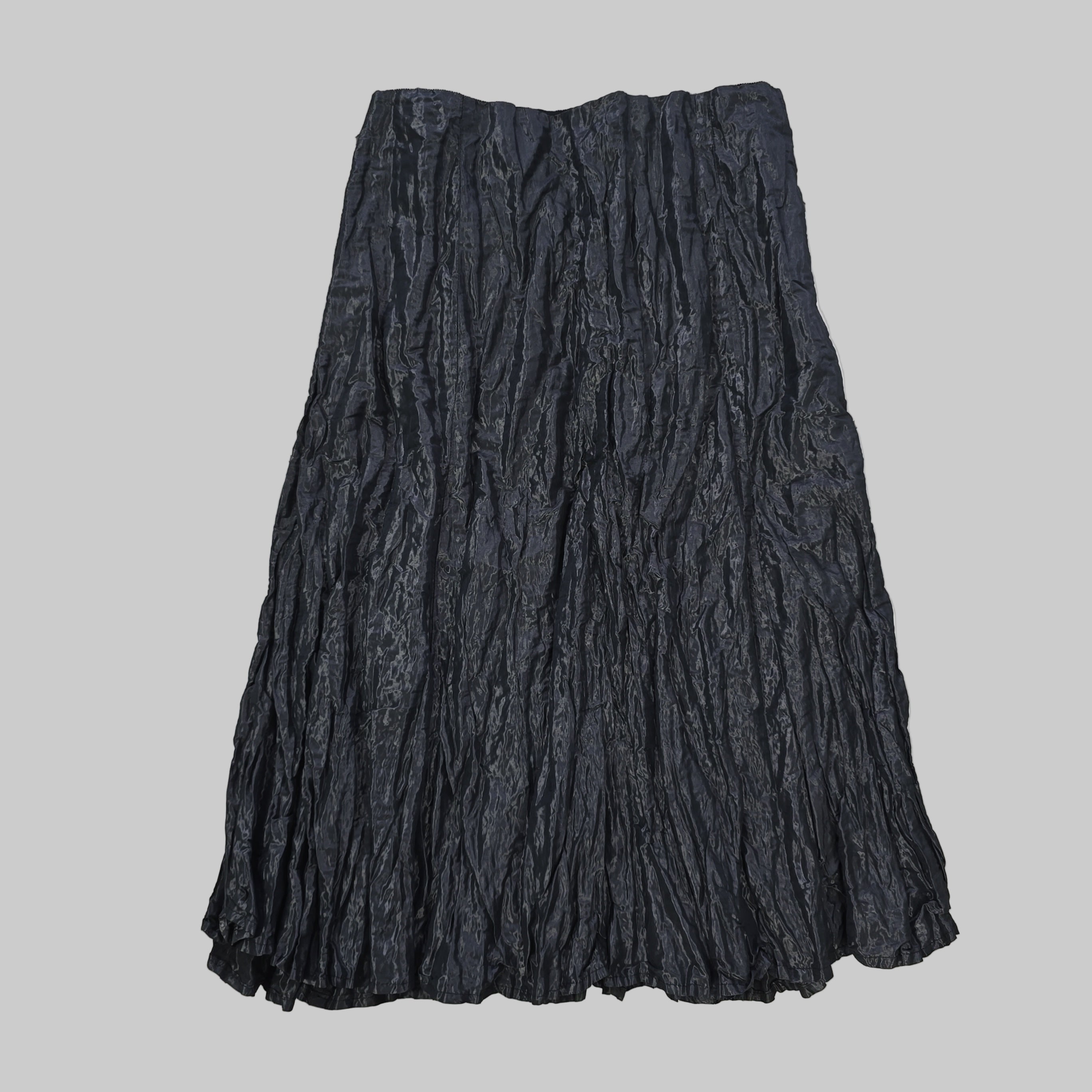 Folded black fabric on a tiled floor