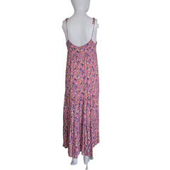 Pink floral dress on a mannequin against a white wall.