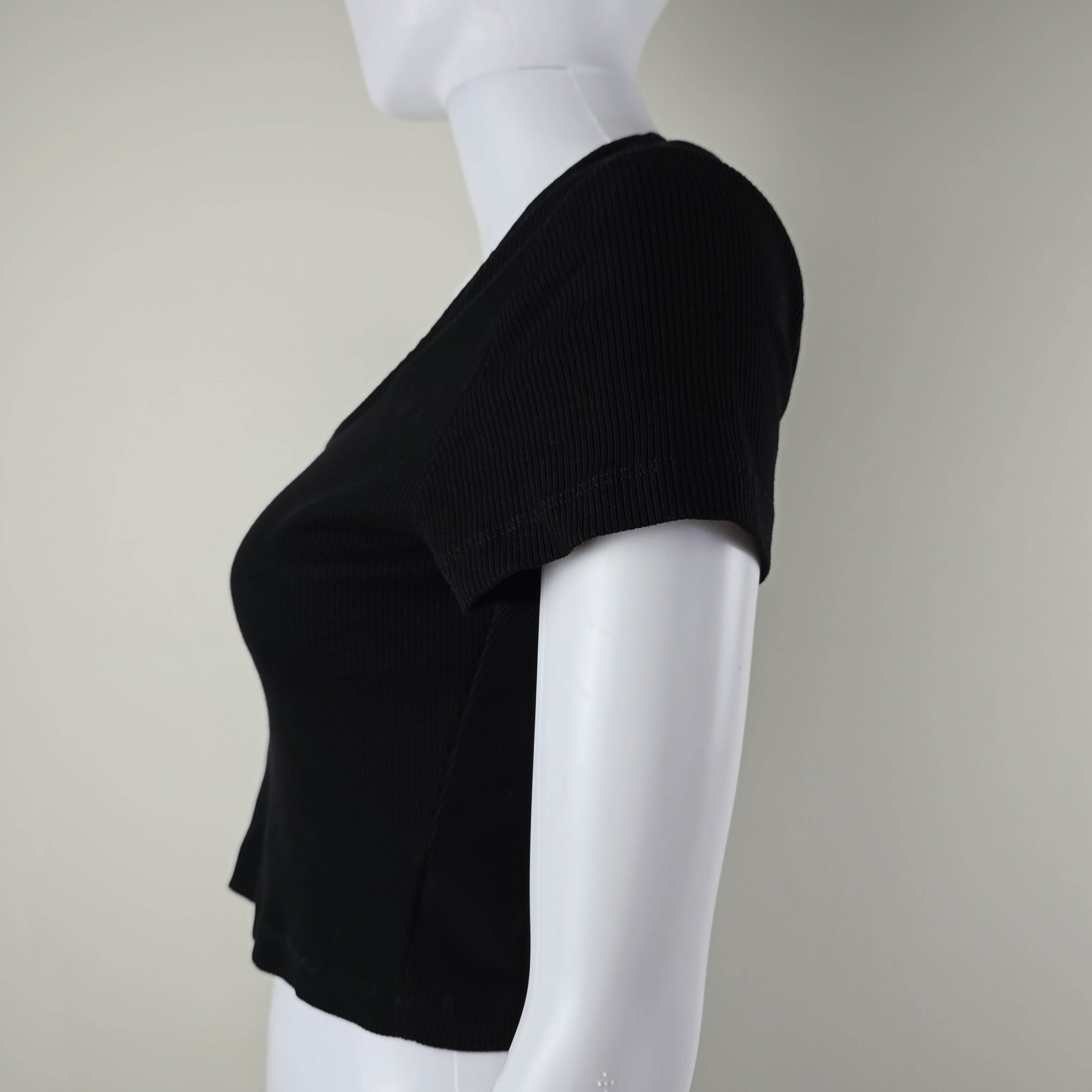 Black top on a white surface with a neutral background