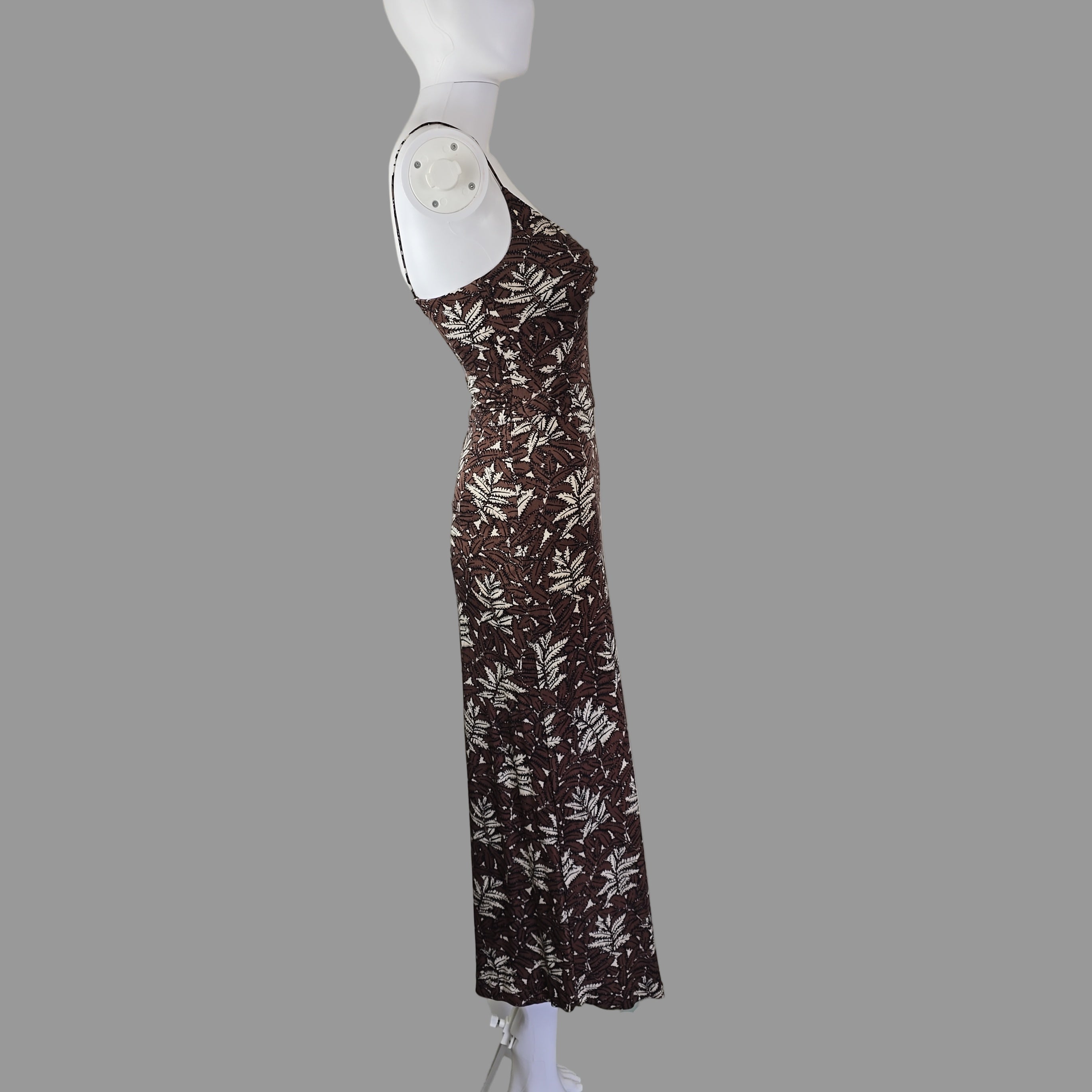 Brown floral-patterned dress on a mannequin arm against a white background