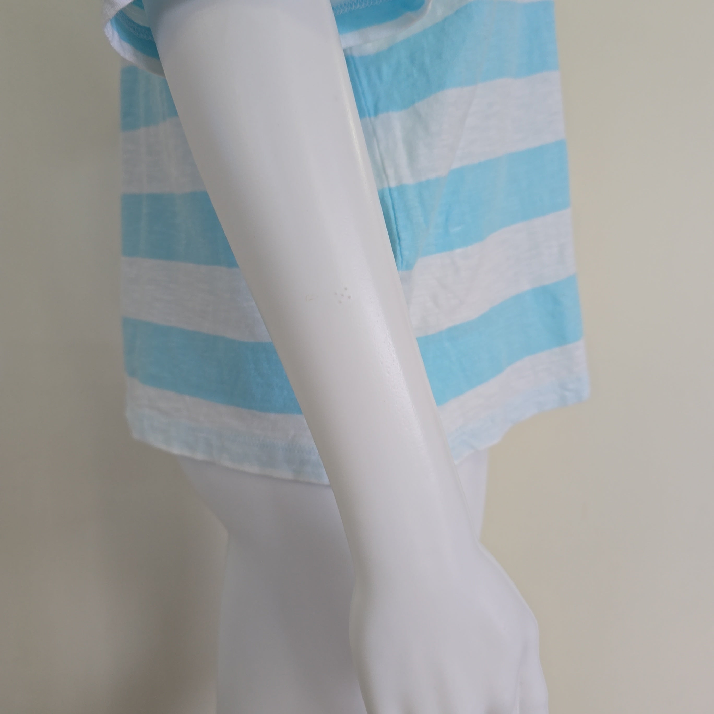 Light blue and white striped shirt on a light background
