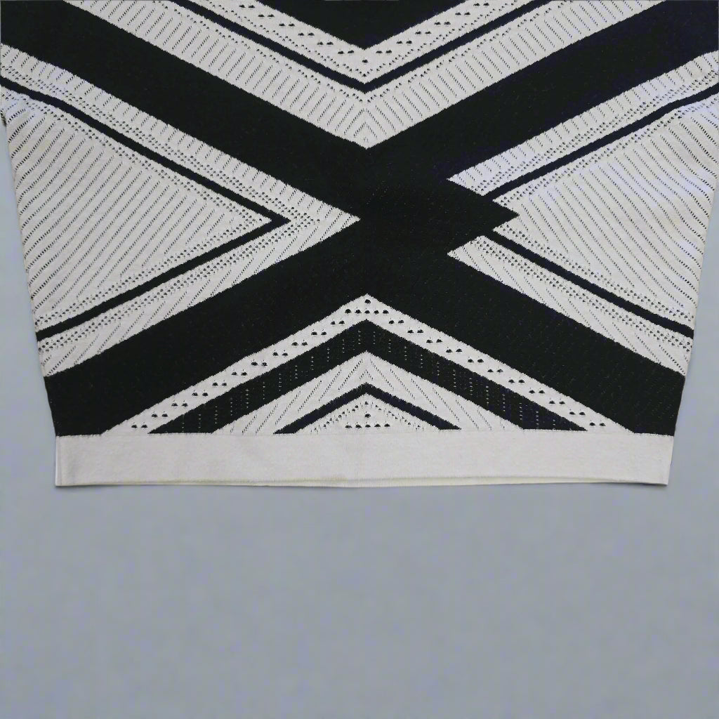 Black and white geometric patterned top on a tiled floor