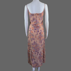 Floral dress on a mannequin against a white wall.