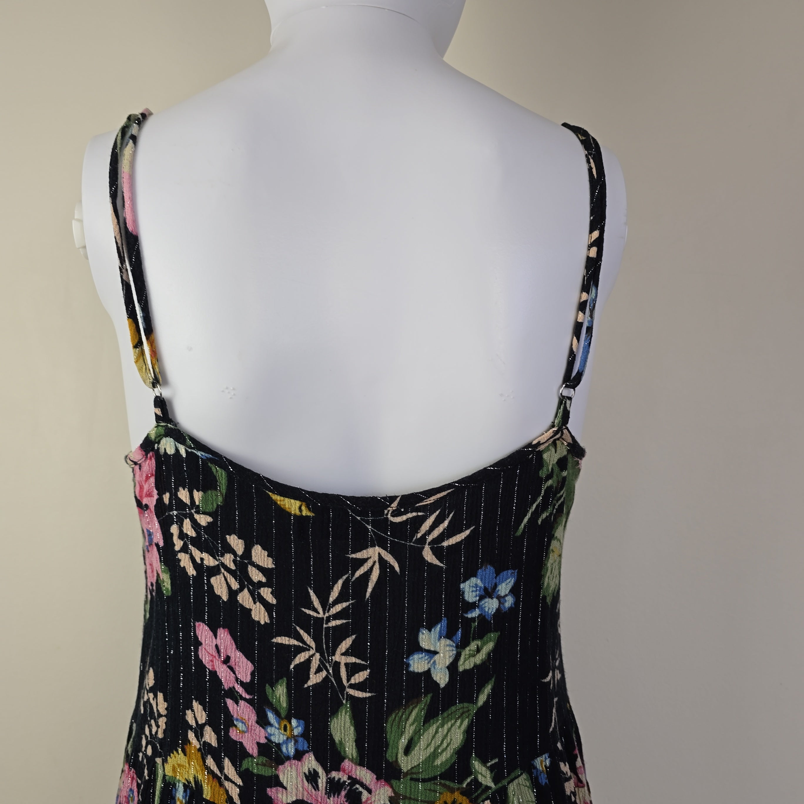 Black floral-patterned top on a light background