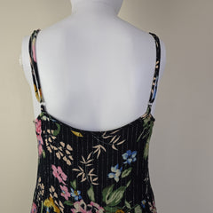 Black floral-patterned top on a light background