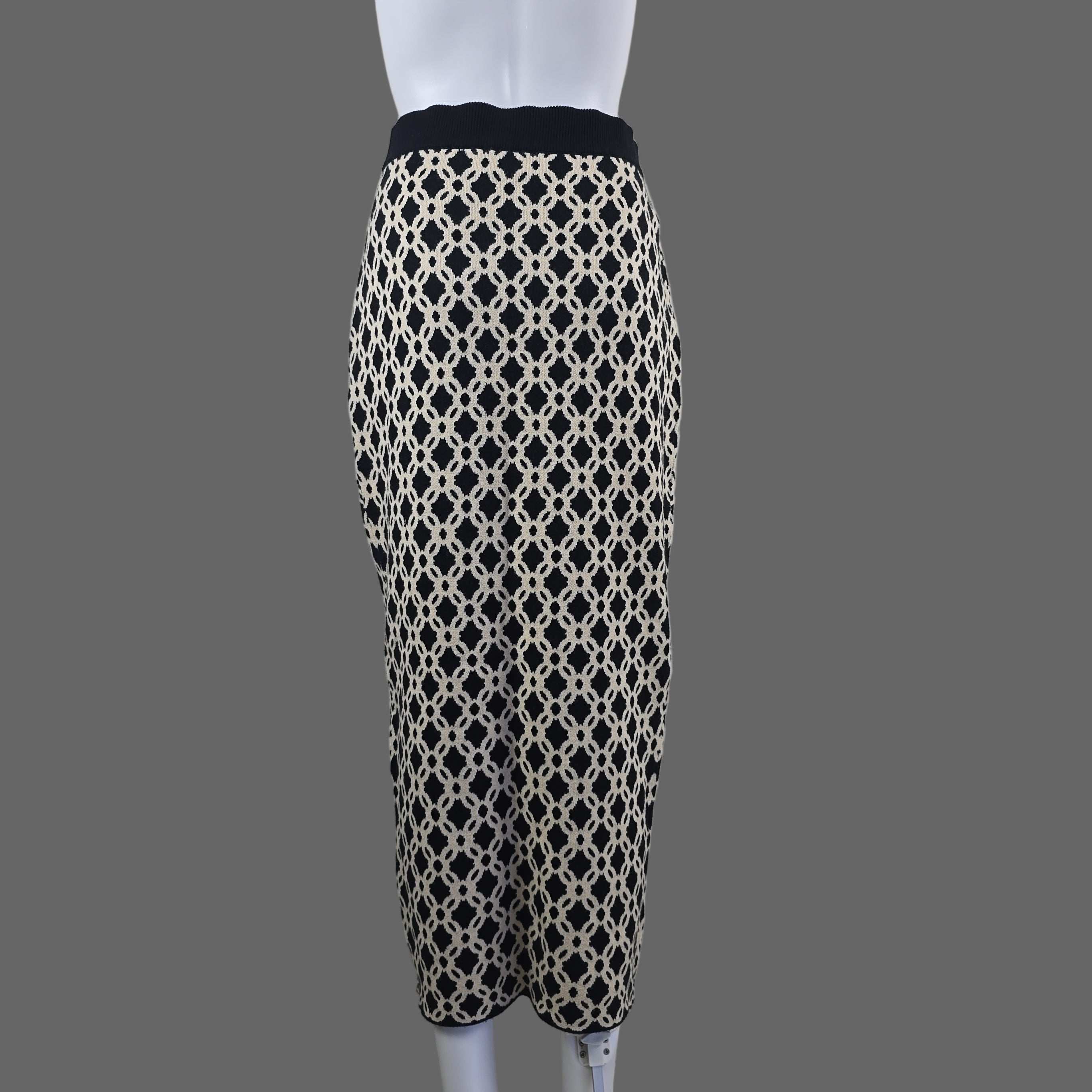 Patterned black and white garment on a white hanger against a neutral background