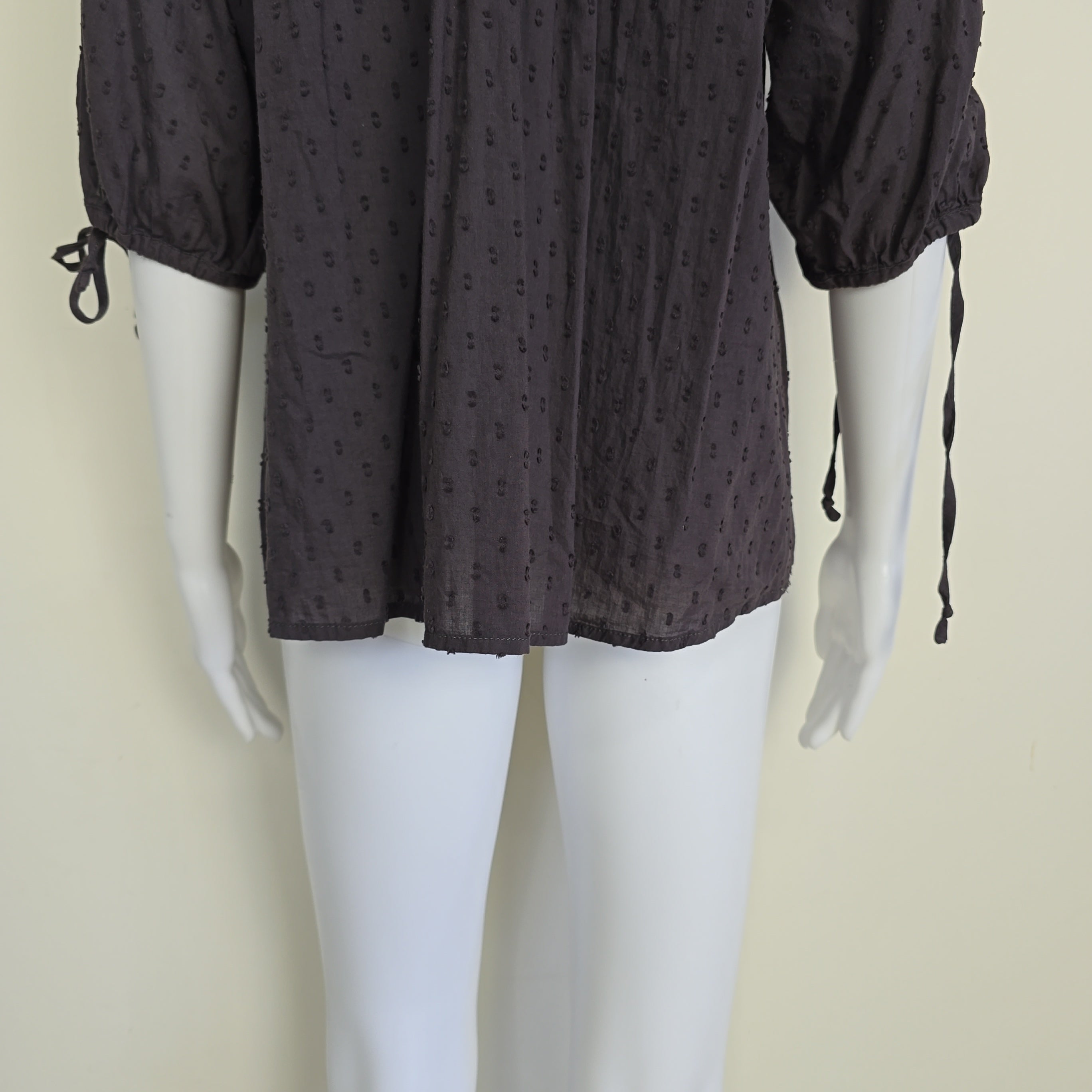 Brown long-sleeve top on a light background