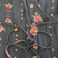 Black fabric with red floral patterns and a black belt on top
