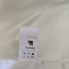 Fabric tag on a beige fabric background with 'Turkey' text.