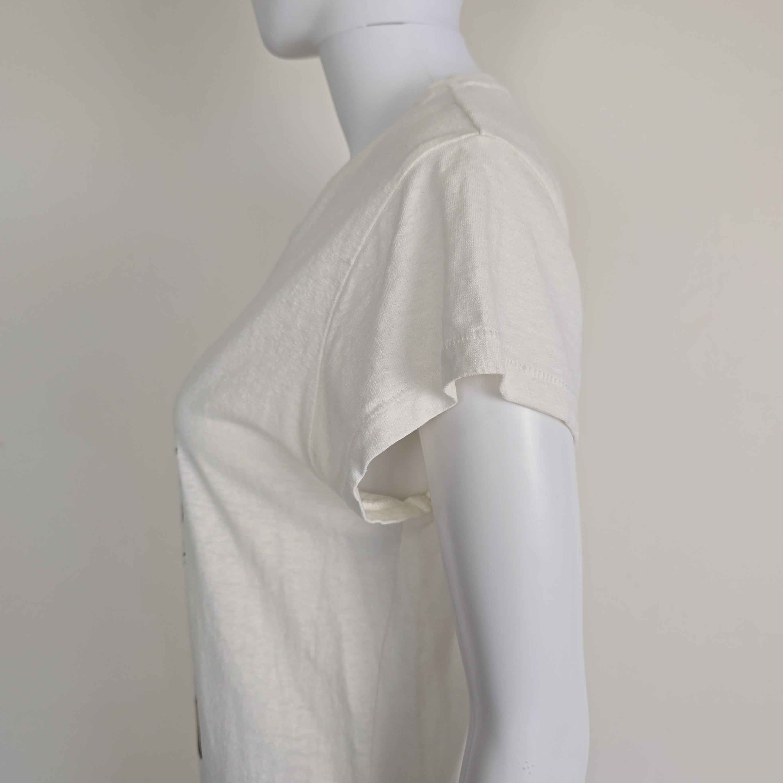 White top on a mannequin with a plain background