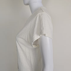 White top on a mannequin with a plain background