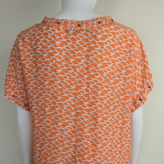 Orange patterned fabric on a white background