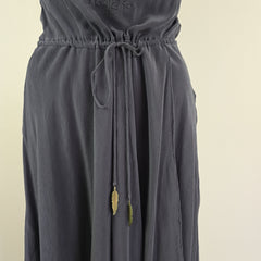 Dark gray fabric with a close-up of stitching details on a beige background