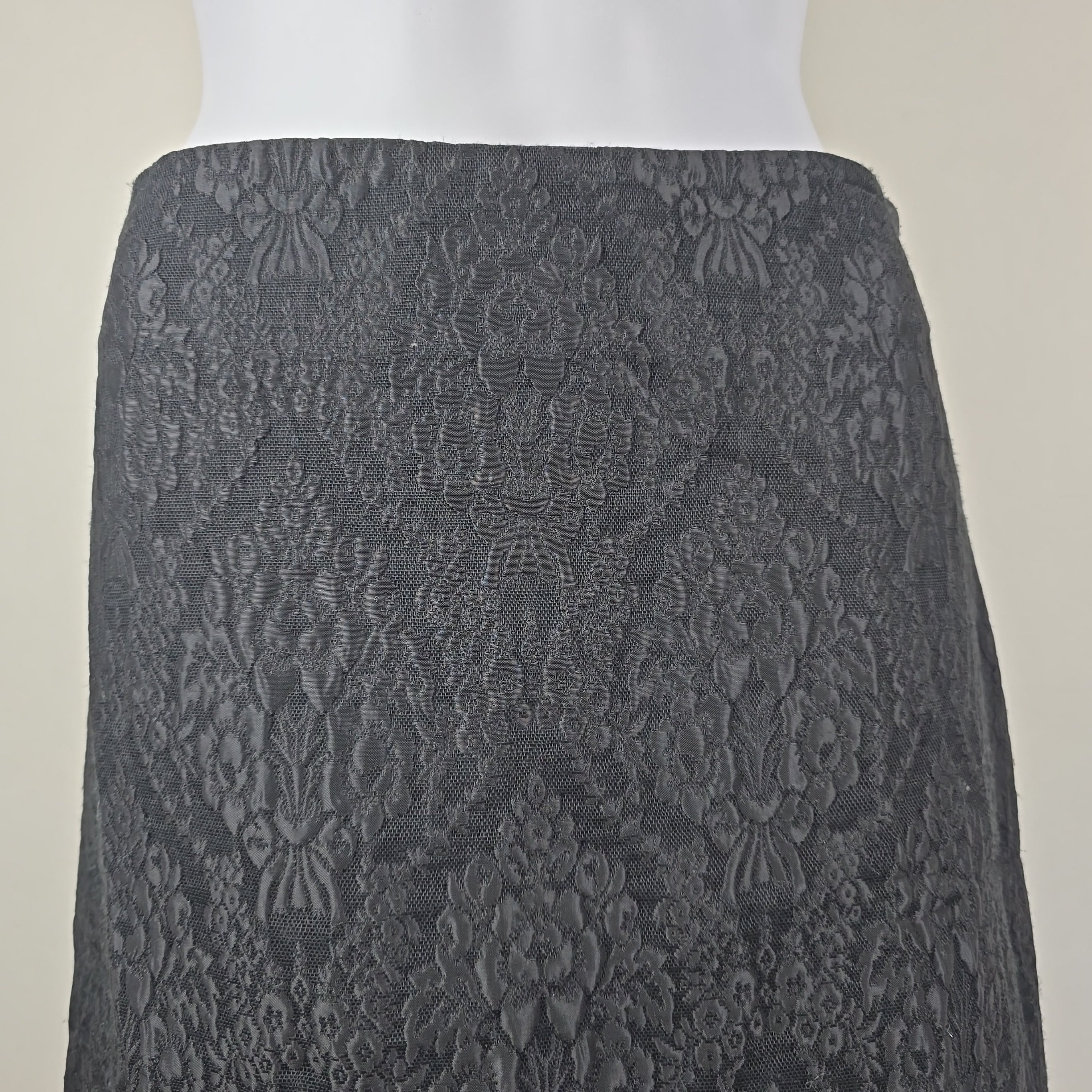 Black textured skirt on a light background