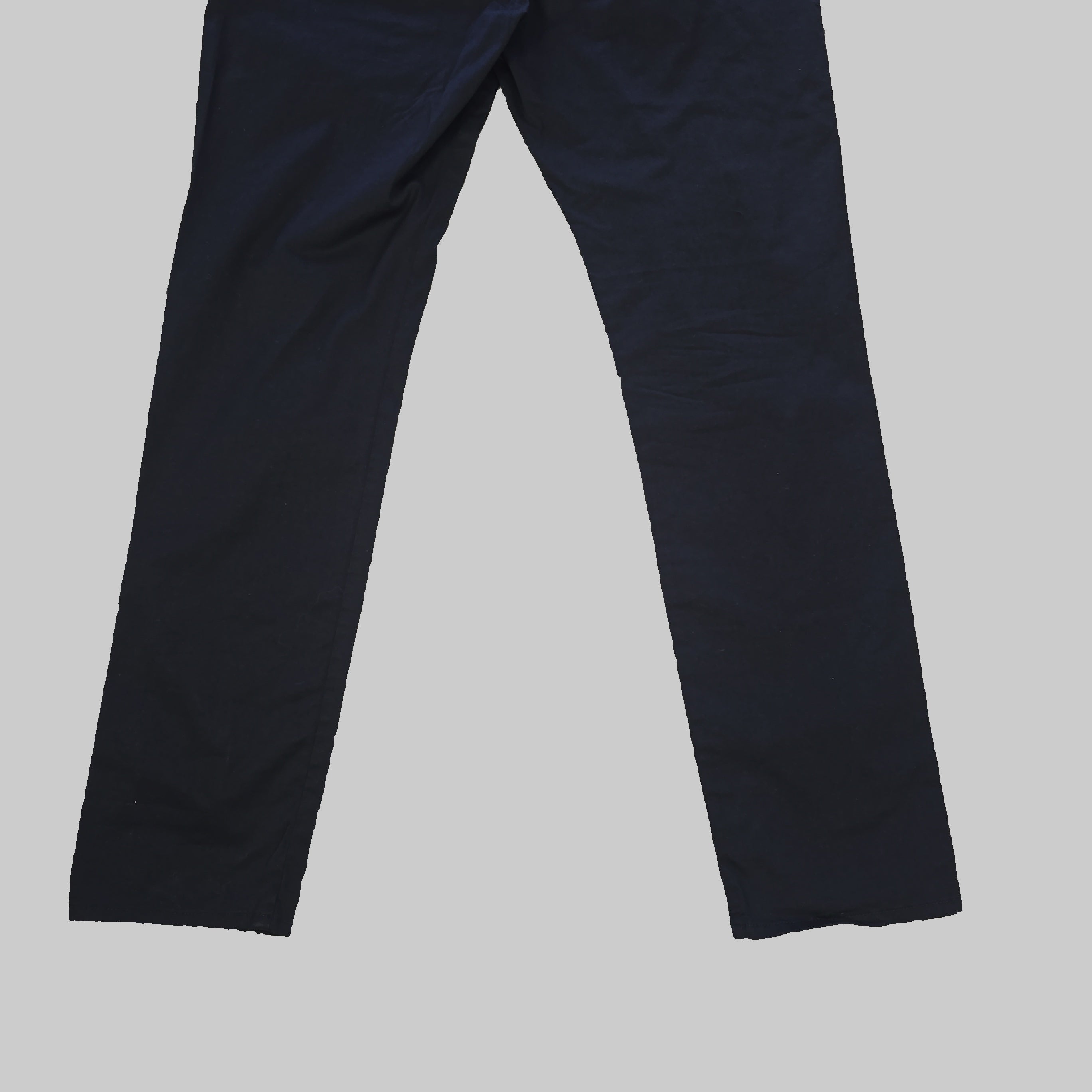 Pair of black pants on a tiled floor