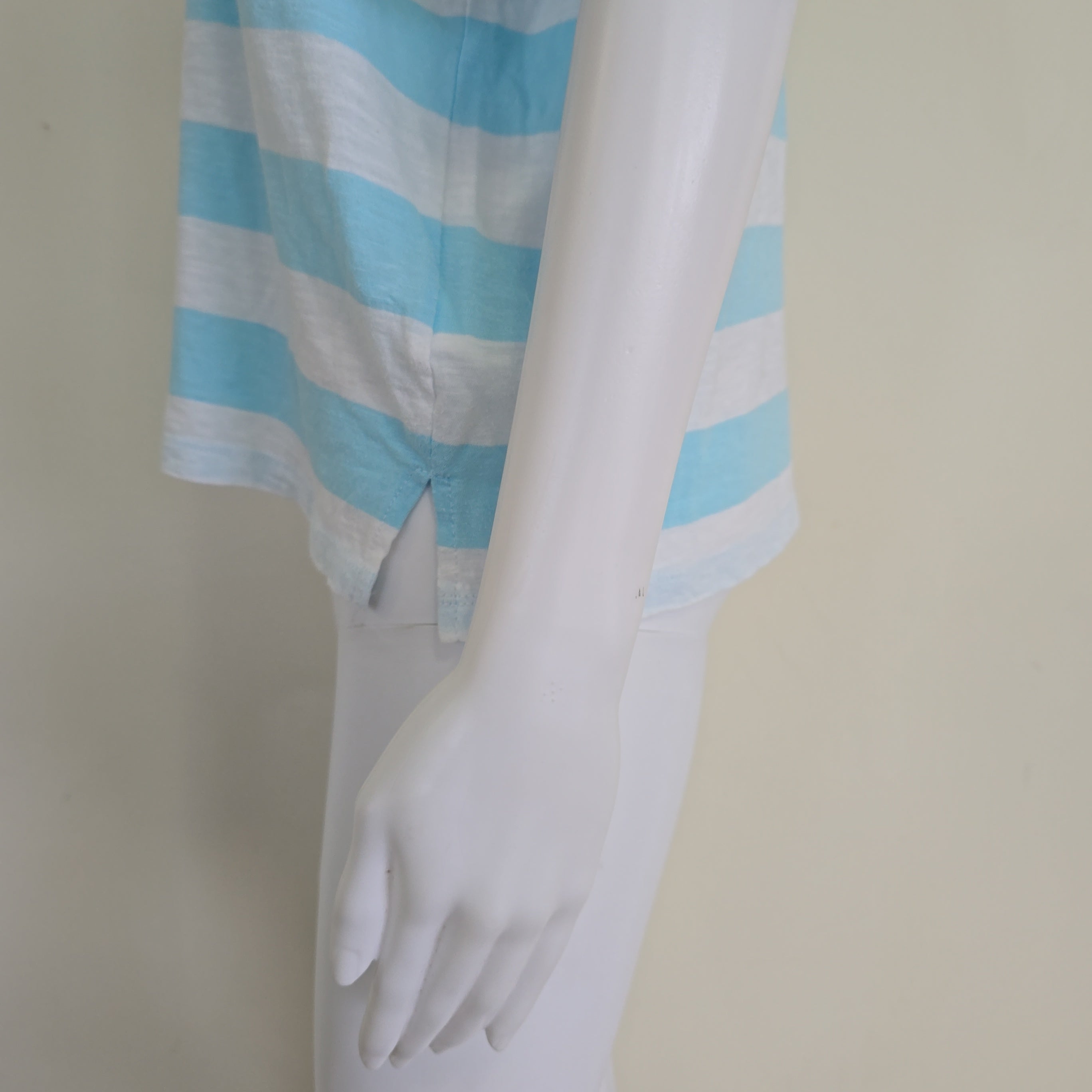 Light blue and white striped shirt on a light background