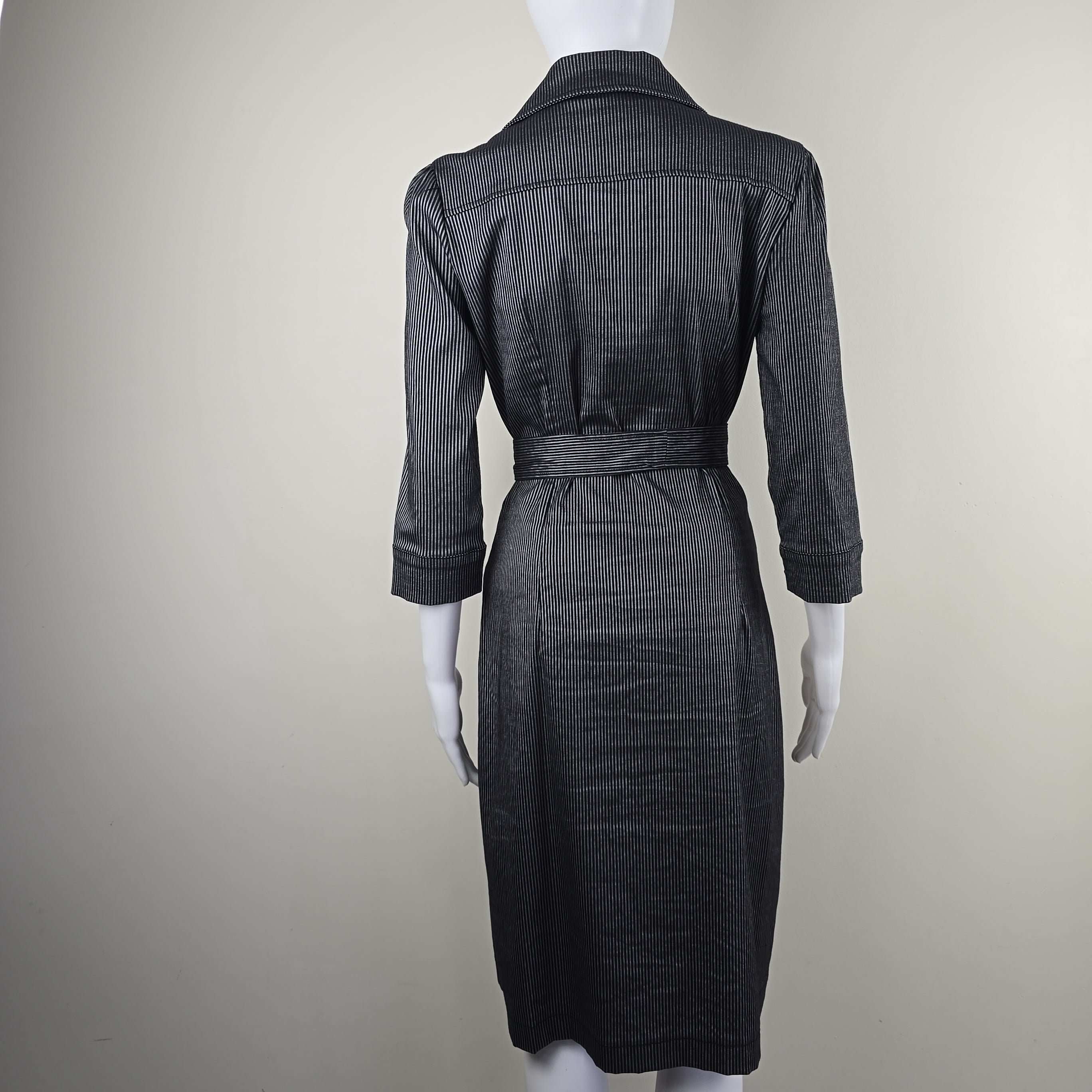 Black pinstripe suit on a mannequin against a plain background