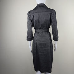 Black pinstripe suit on a mannequin against a plain background