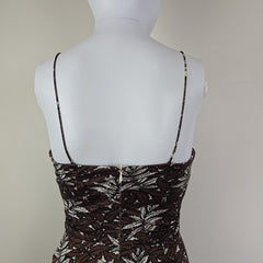 Mannequin wearing a patterned dress with a plain background