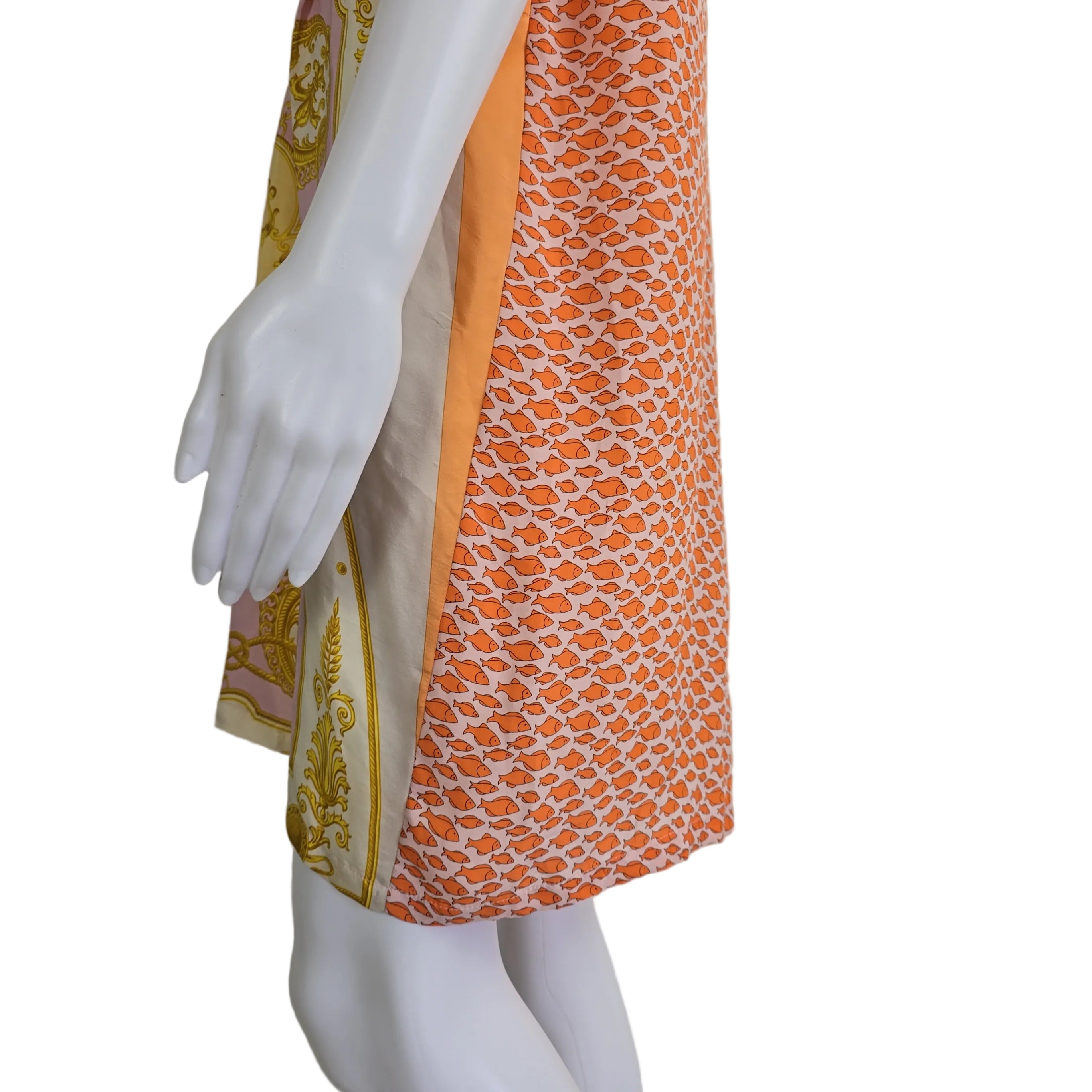 Decorative pink and yellow patterned fabric kaftan on a light background.