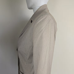 Mannequin wearing a gray textured blazer on a plain background